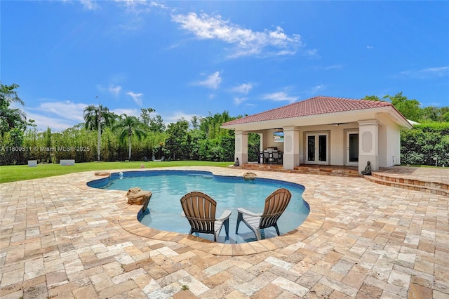 5963 NW 75th Way, Parkland, FL 33067 - swimming pool featuring french doors, a patio area, a storage structure, an outbuilding, and area for grilling