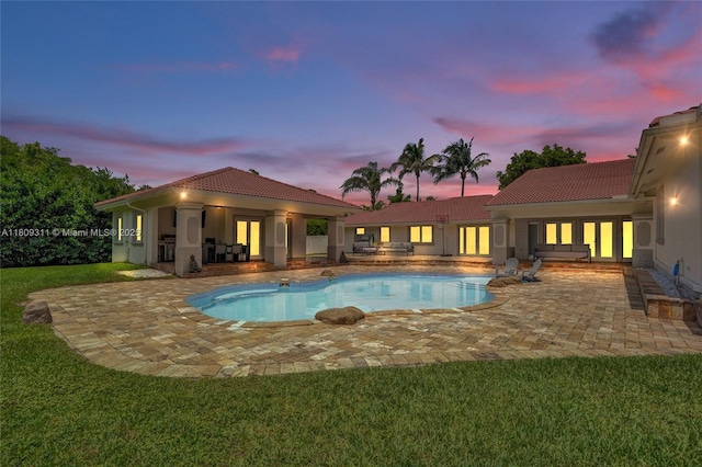 5963 NW 75th Way, Parkland, FL 33067 - pool at dusk featuring french doors, a patio area, an outdoor pool, and a lawn