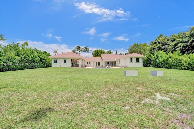 5963 NW 75th Way, Parkland, FL 33067 - back of house featuring a yard, a patio area, and stucco siding