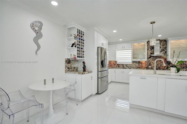 8438 NW 26th Dr, Coral Springs, FL 33065 - kitchen with wall chimney exhaust hood, stainless steel fridge, tasteful backsplash, white cabinetry, and recessed lighting