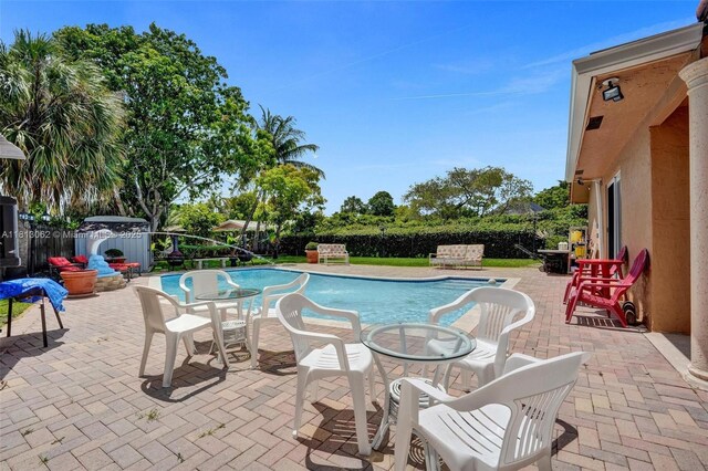 8438 NW 26th Dr, Coral Springs, FL 33065 - view of swimming pool featuring a patio