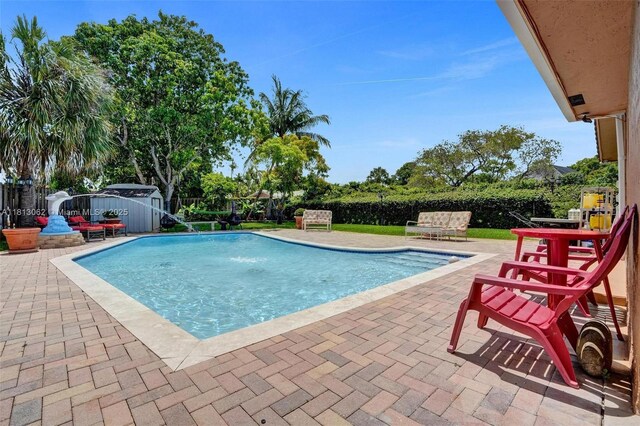 8438 NW 26th Dr, Coral Springs, FL 33065 - view of pool featuring a patio area and a shed