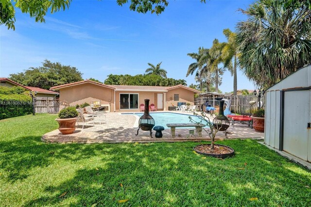 8438 NW 26th Dr, Coral Springs, FL 33065 - back of house with a fenced backyard, a shed, a patio, and stucco siding
