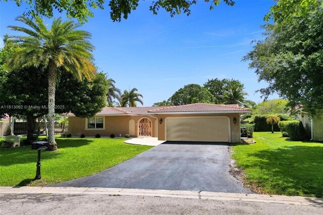 8438 NW 26th Dr, Coral Springs, FL 33065 - view of front of property with stucco siding, a garage, driveway, a tiled roof, and a front lawn