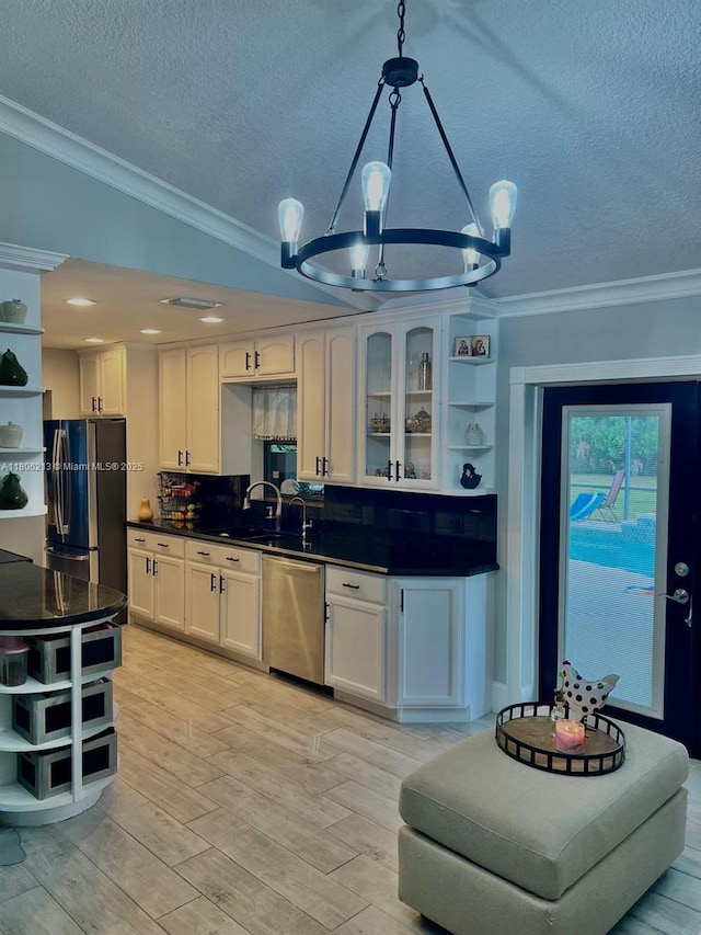 11613 N 42nd Rd N, West Palm Beach, FL 33411 - kitchen with open shelves, stainless steel appliances, a chandelier, ornamental molding, and dark countertops