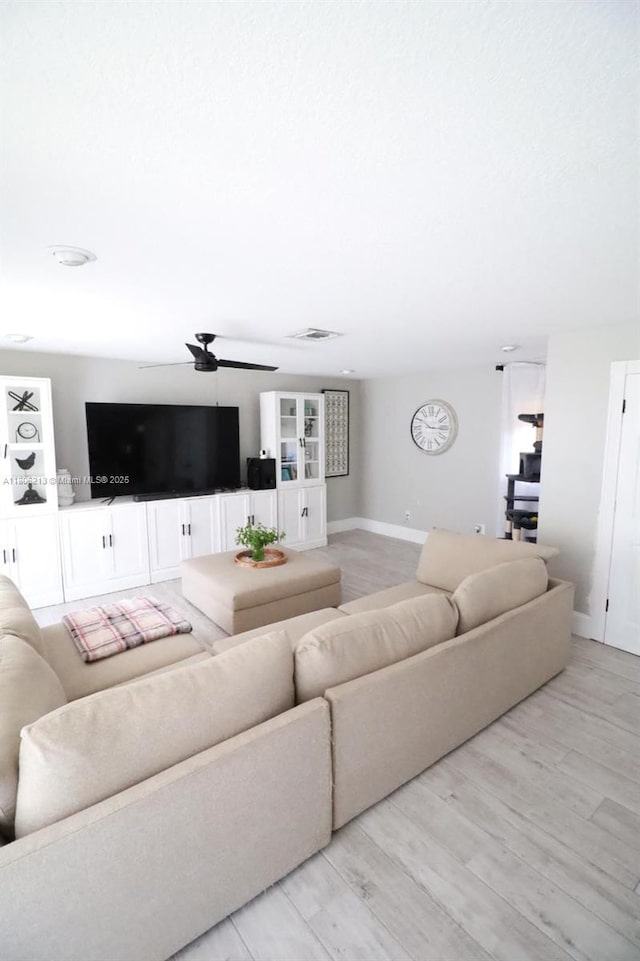 11613 N 42nd Rd N, West Palm Beach, FL 33411 - living area with a ceiling fan, light wood finished floors, and baseboards