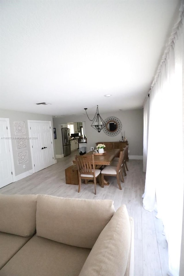 11613 N 42nd Rd N, West Palm Beach, FL 33411 - living room featuring baseboards and light wood-type flooring