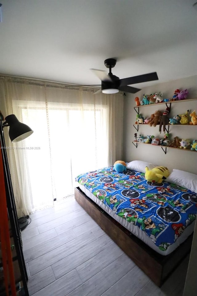 11613 N 42nd Rd N, West Palm Beach, FL 33411 - bedroom with a ceiling fan and wood finished floors