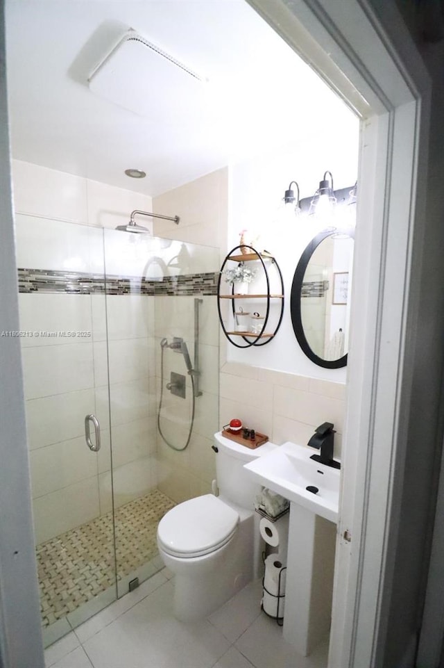 11613 N 42nd Rd N, West Palm Beach, FL 33411 - full bathroom with tile walls, a stall shower, toilet, and tile patterned floors