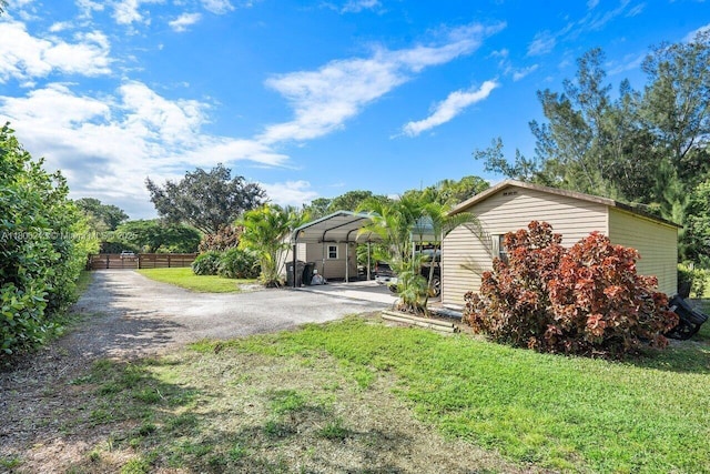 11613 N 42nd Rd N, West Palm Beach, FL 33411 - view of front of house featuring a detached carport and driveway