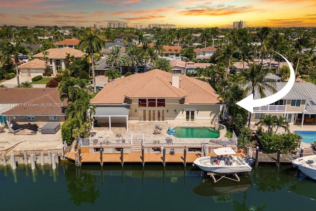 4241 NE 23rd Ter, Lighthouse Point, FL 33064 - aerial view at dusk of a water view and view of pool