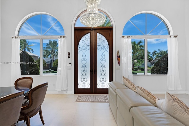 4241 NE 23rd Ter, Lighthouse Point, FL 33064 - tiled foyer entrance with french doors and a chandelier