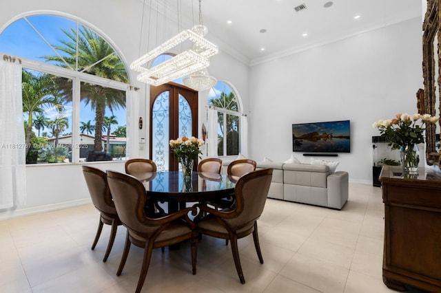 4241 NE 23rd Ter, Lighthouse Point, FL 33064 - dining area featuring a high ceiling, ornamental molding, and a chandelier