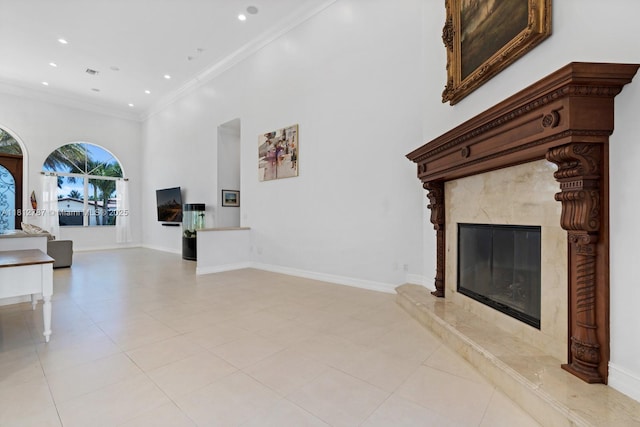 4241 NE 23rd Ter, Lighthouse Point, FL 33064 - unfurnished living room featuring recessed lighting, a fireplace, a towering ceiling, ornamental molding, and light tile patterned flooring