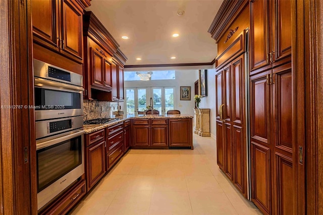 4241 NE 23rd Ter, Lighthouse Point, FL 33064 - kitchen featuring stainless steel appliances, a peninsula, light stone countertops, ornamental molding, and backsplash