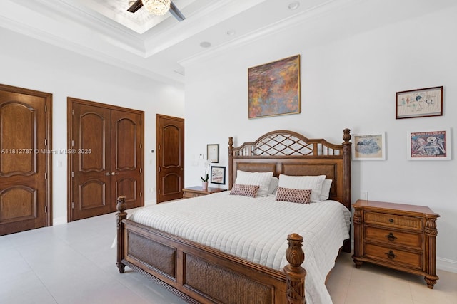 4241 NE 23rd Ter, Lighthouse Point, FL 33064 - bedroom featuring multiple closets, a ceiling fan, light tile patterned floors, and a raised ceiling