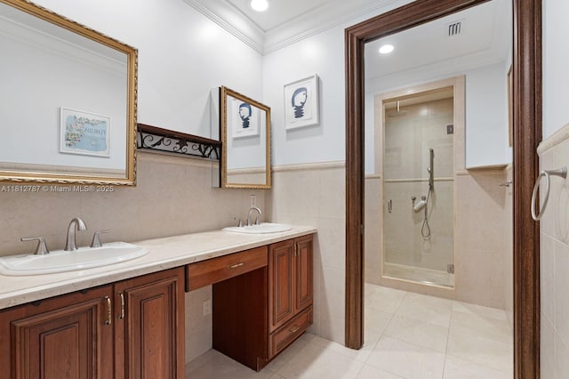 4241 NE 23rd Ter, Lighthouse Point, FL 33064 - bathroom featuring a stall shower, crown molding, double vanity, tile walls, and a wainscoted wall