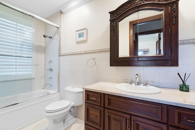 4241 NE 23rd Ter, Lighthouse Point, FL 33064 - bathroom featuring vanity, bath / shower combo with glass door, and tile walls
