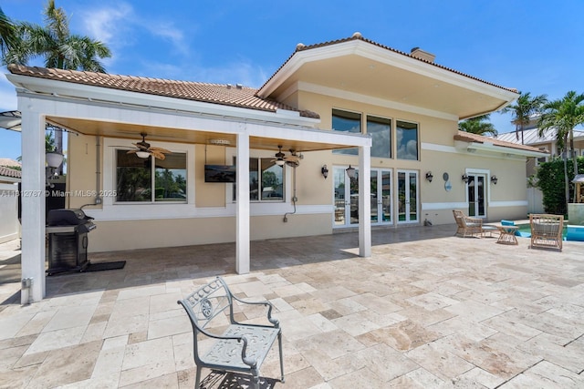 4241 NE 23rd Ter, Lighthouse Point, FL 33064 - back of house with ceiling fan, stucco siding, french doors, a patio area, and a tile roof