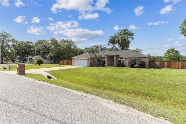 3661 Misty, Woods, FL 32571 - ranch-style home with driveway, a garage, and brick siding