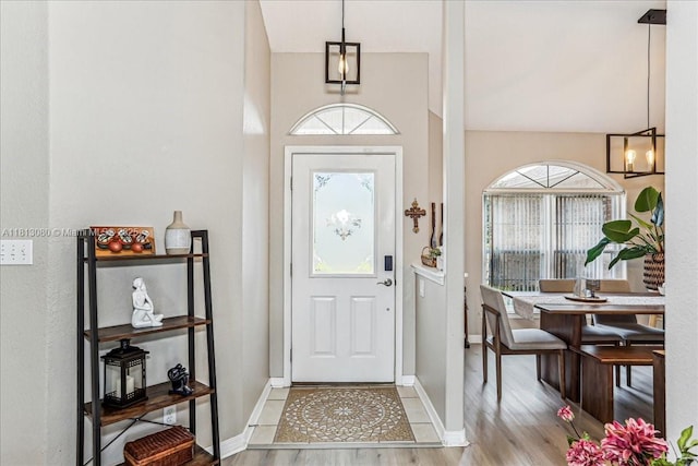 3661 Misty, Woods, FL 32571 - entrance foyer featuring wood finished floors, baseboards, and a chandelier