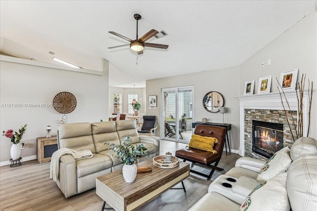 3661 Misty, Woods, FL 32571 - living area with vaulted ceiling, a ceiling fan, light wood finished floors, a stone fireplace, and baseboards
