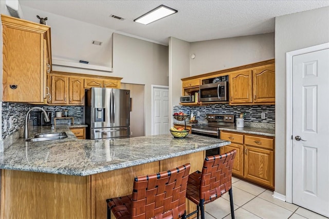 3661 Misty, Woods, FL 32571 - kitchen with appliances with stainless steel finishes, a sink, a peninsula, decorative backsplash, and a textured ceiling