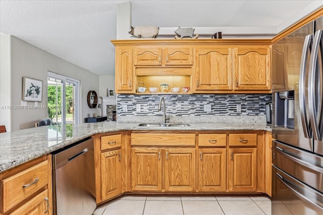 3661 Misty, Woods, FL 32571 - kitchen with appliances with stainless steel finishes, a sink, light stone countertops, backsplash, and light tile patterned flooring