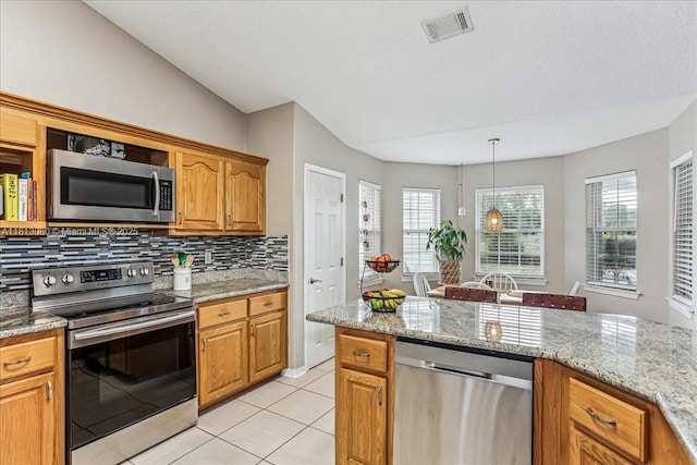 3661 Misty, Woods, FL 32571 - kitchen with stainless steel appliances, tasteful backsplash, plenty of natural light, and light tile patterned floors