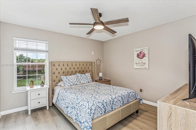 3661 Misty, Woods, FL 32571 - bedroom with light wood-style floors, baseboards, a ceiling fan, and a textured ceiling