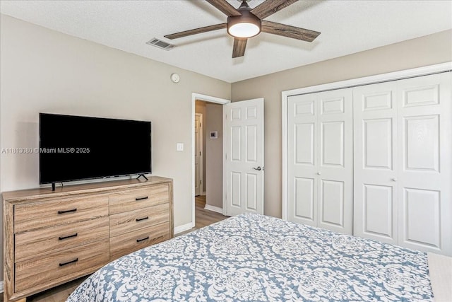 3661 Misty, Woods, FL 32571 - bedroom featuring a closet, wood finished floors, ceiling fan, baseboards, and a textured ceiling