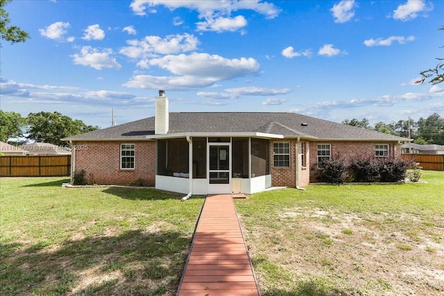 3661 Misty, Woods, FL 32571 - back of house featuring a sunroom, a chimney, and brick siding