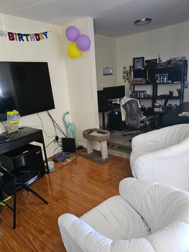 2418 NE 10th St Unit 127, Hallandale Beach, FL 33009 - living room with wood finished floors and a desk