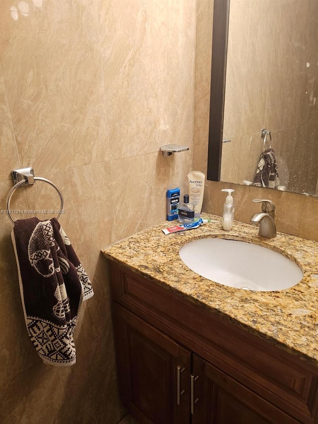 2418 NE 10th St Unit 127, Hallandale Beach, FL 33009 - bathroom with vanity and tile walls