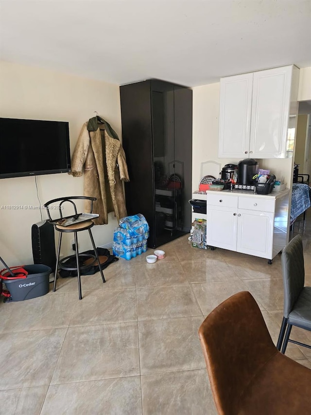 2418 NE 10th St Unit 127, Hallandale Beach, FL 33009 - kitchen featuring white cabinets and light countertops