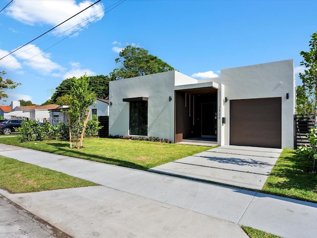 1735 SW 24th Ter, Miami, FL 33145 - modern home with driveway, a garage, stucco siding, and a front yard