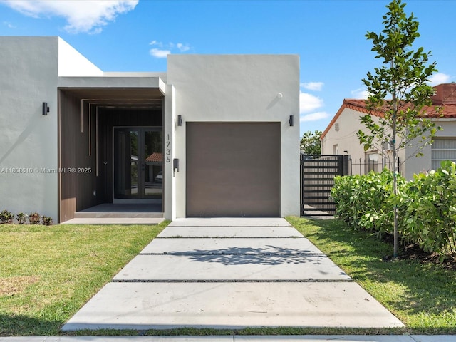 1735 SW 24th Ter, Miami, FL 33145 - view of front of house with driveway, an attached garage, and stucco siding