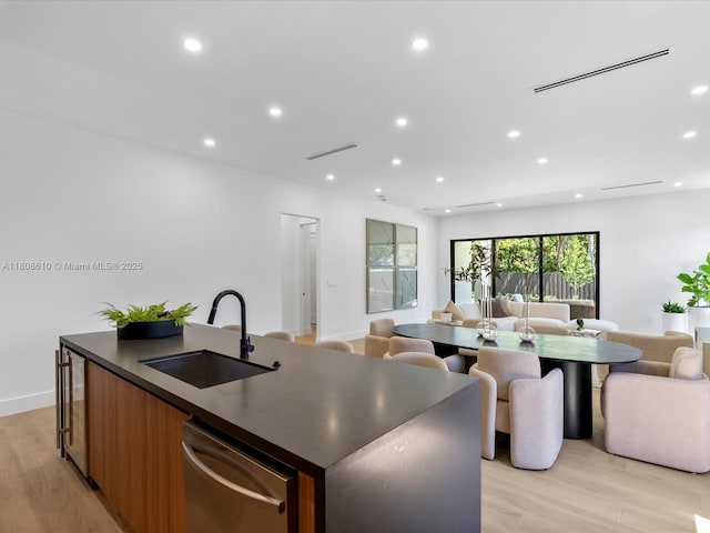 1735 SW 24th Ter, Miami, FL 33145 - kitchen featuring open floor plan, dishwasher, a sink, dark countertops, and a kitchen island with sink
