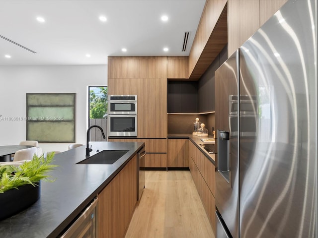 1735 SW 24th Ter, Miami, FL 33145 - kitchen featuring appliances with stainless steel finishes, modern cabinets, a sink, dark countertops, and recessed lighting