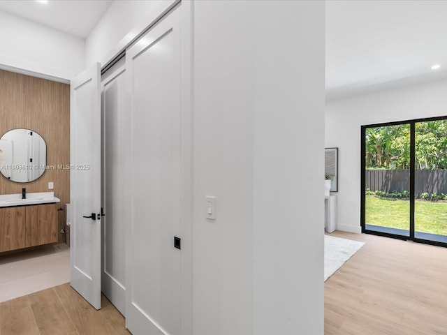 1735 SW 24th Ter, Miami, FL 33145 - corridor with light wood-type flooring, a sink, and recessed lighting