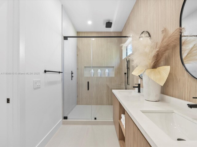 1735 SW 24th Ter, Miami, FL 33145 - bathroom featuring tile patterned floors, a shower stall, double vanity, and baseboards
