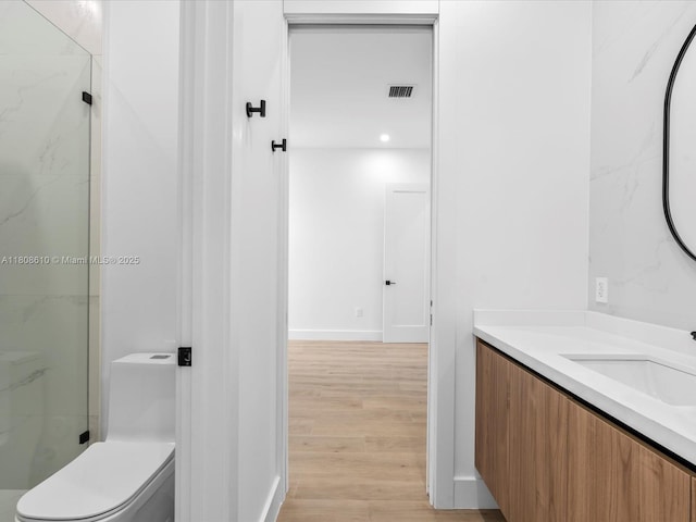 1735 SW 24th Ter, Miami, FL 33145 - bathroom with vanity, wood finished floors, a marble finish shower, toilet, and baseboards
