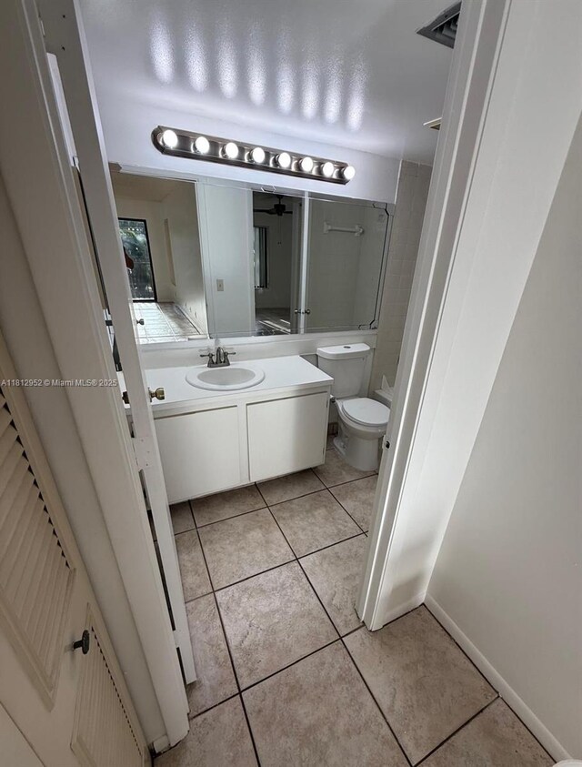 721 Sunny Pine Way Unit D2, Green Acres, FL 33415 - full bathroom featuring tile patterned flooring, vanity, toilet, and baseboards