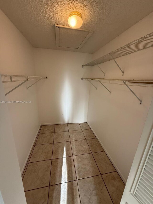721 Sunny Pine Way Unit D2, Green Acres, FL 33415 - spacious closet featuring light tile patterned floors and attic access