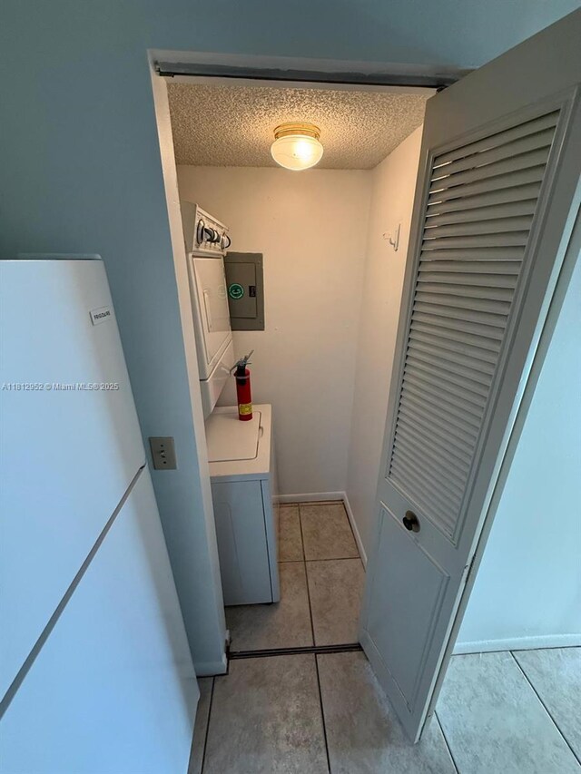721 Sunny Pine Way Unit D2, Green Acres, FL 33415 - laundry room with light tile patterned floors, a textured ceiling, and electric panel