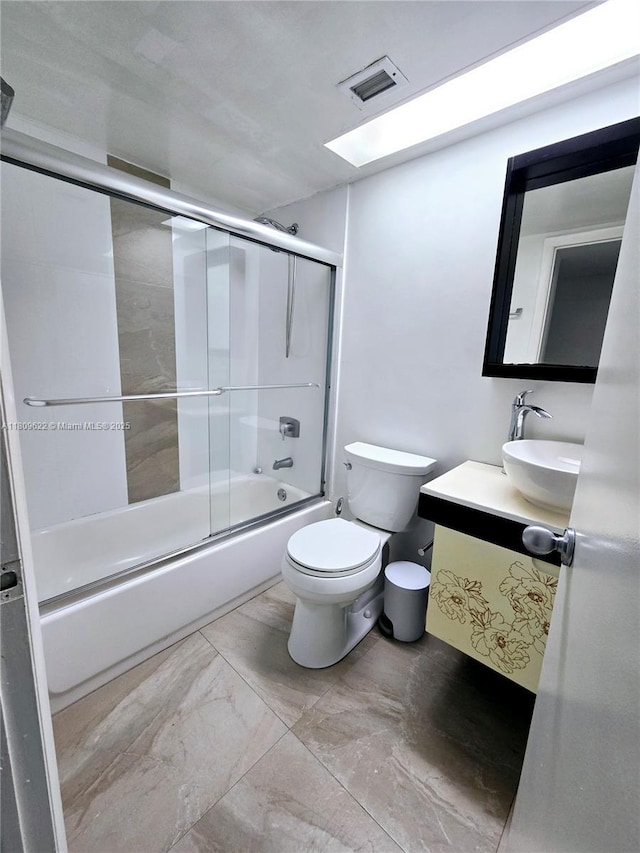 17890 W Dixie Hwy Unit 302, Miami, FL 33160 - bathroom featuring vanity, toilet, bath / shower combo with glass door, and marble finish flooring
