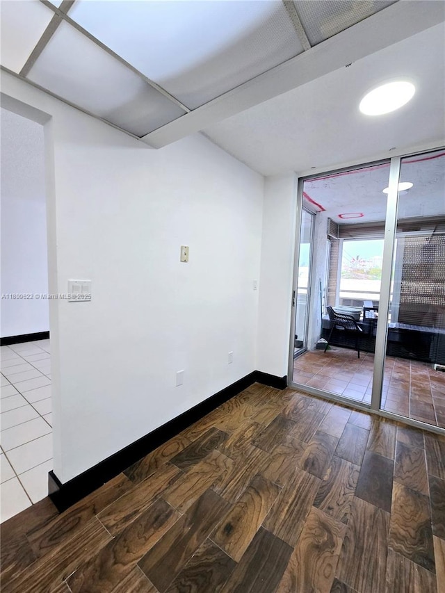 17890 W Dixie Hwy Unit 302, Miami, FL 33160 - unfurnished room with wood finished floors, baseboards, and floor to ceiling windows