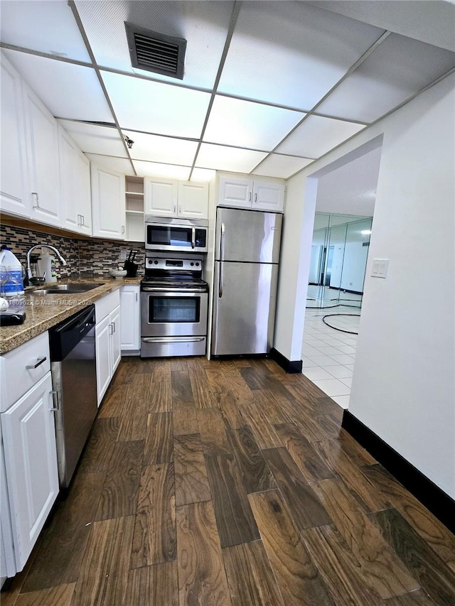 17890 W Dixie Hwy Unit 302, Miami, FL 33160 - kitchen with appliances with stainless steel finishes, a sink, dark wood-style floors, and white cabinetry