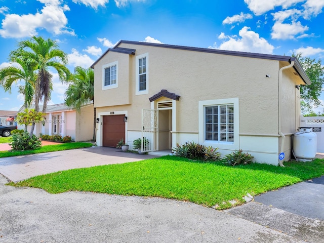 6566 NW 197th Ln, Hialeah, FL 33015 - townhome / multi-family property with a garage, stucco siding, driveway, and a front lawn