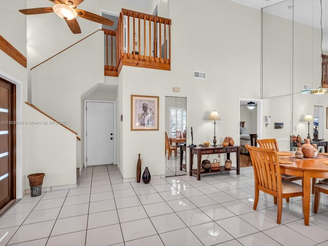6566 NW 197th Ln, Hialeah, FL 33015 - dining space with a high ceiling, a ceiling fan, light tile patterned flooring, and stairway